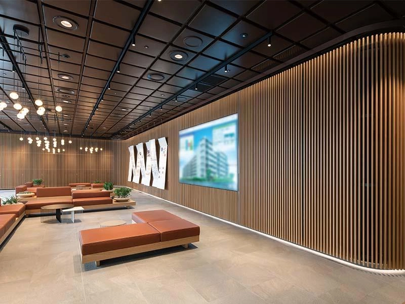 Dark vertical wood slat wall paired with light neutral flooring in a modern commercial office interior